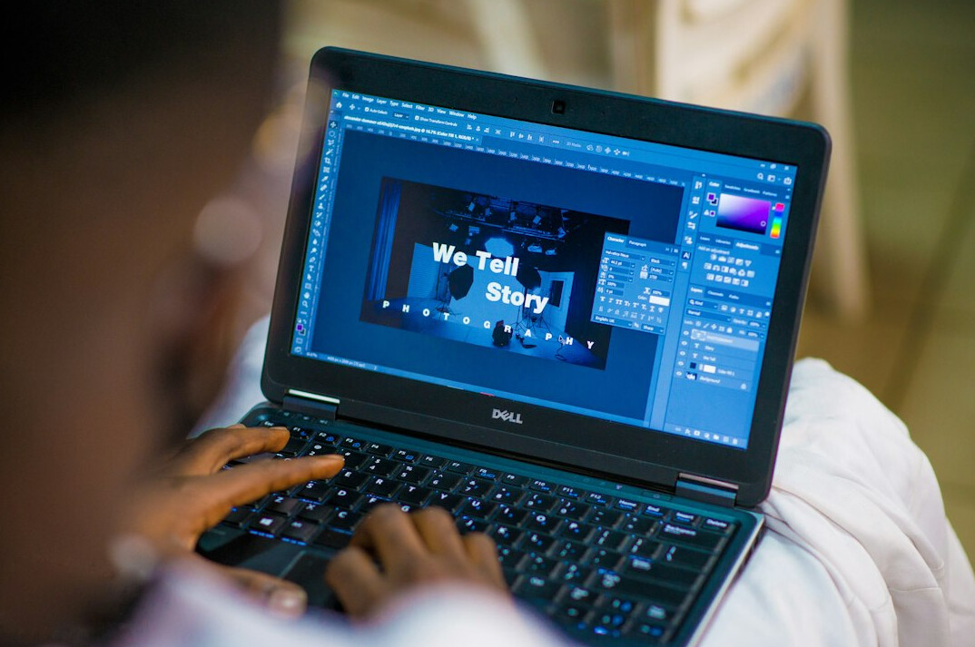 student coding on laptop