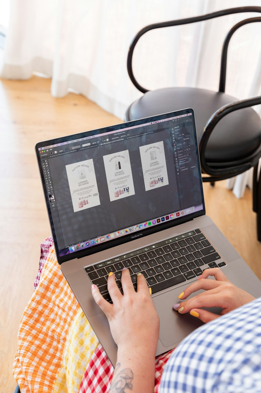person coding on laptop with books