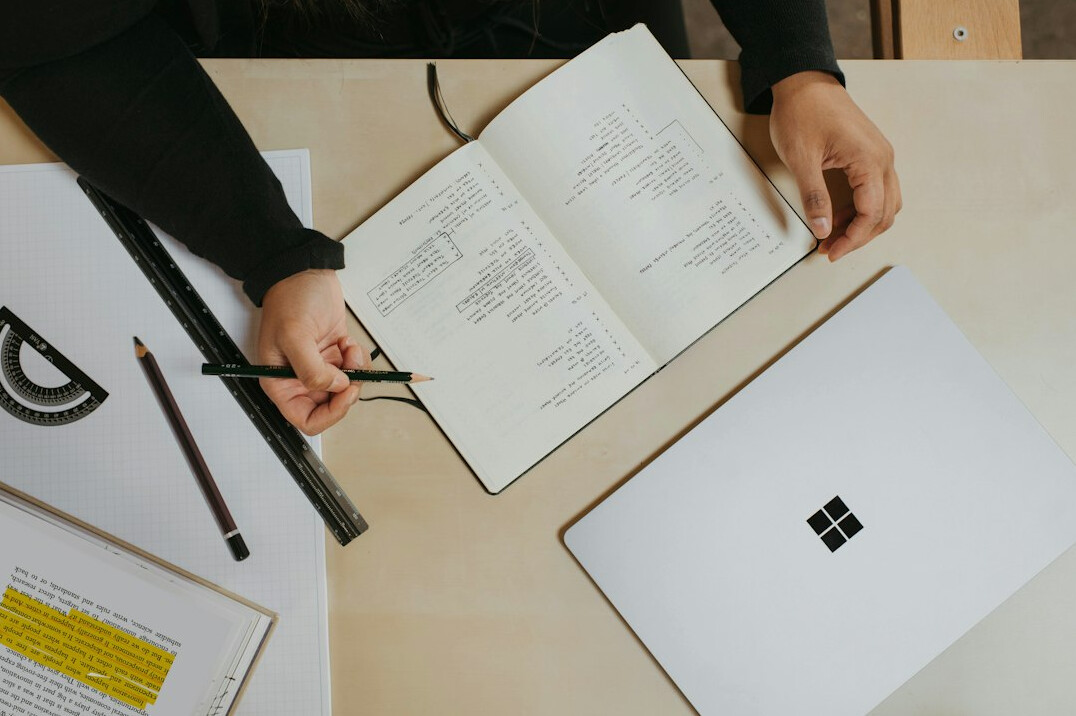 person taking notes on notebook