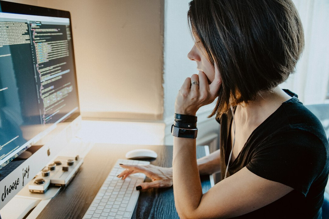 woman coding at desk