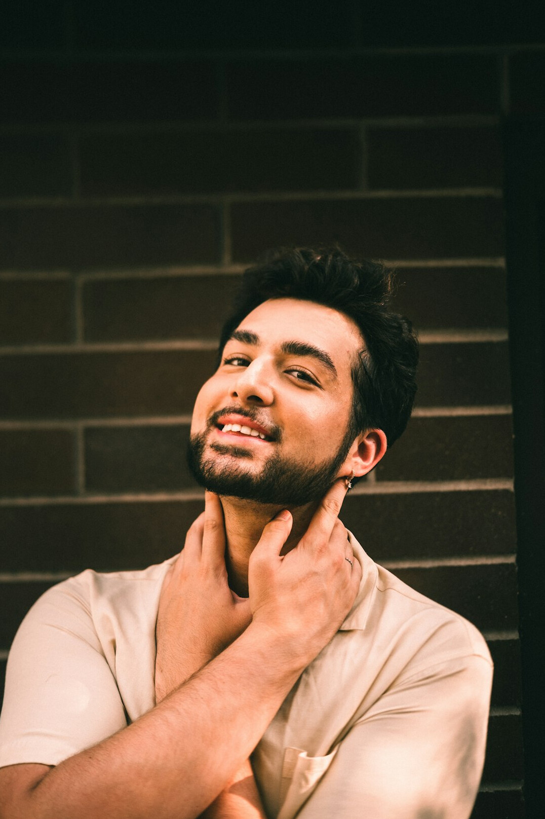 Studio portrait of a Malay man in a collared shirt